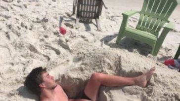 Funny Beach Picture Of A Guy Sleeping In Handmade Hole On Beach